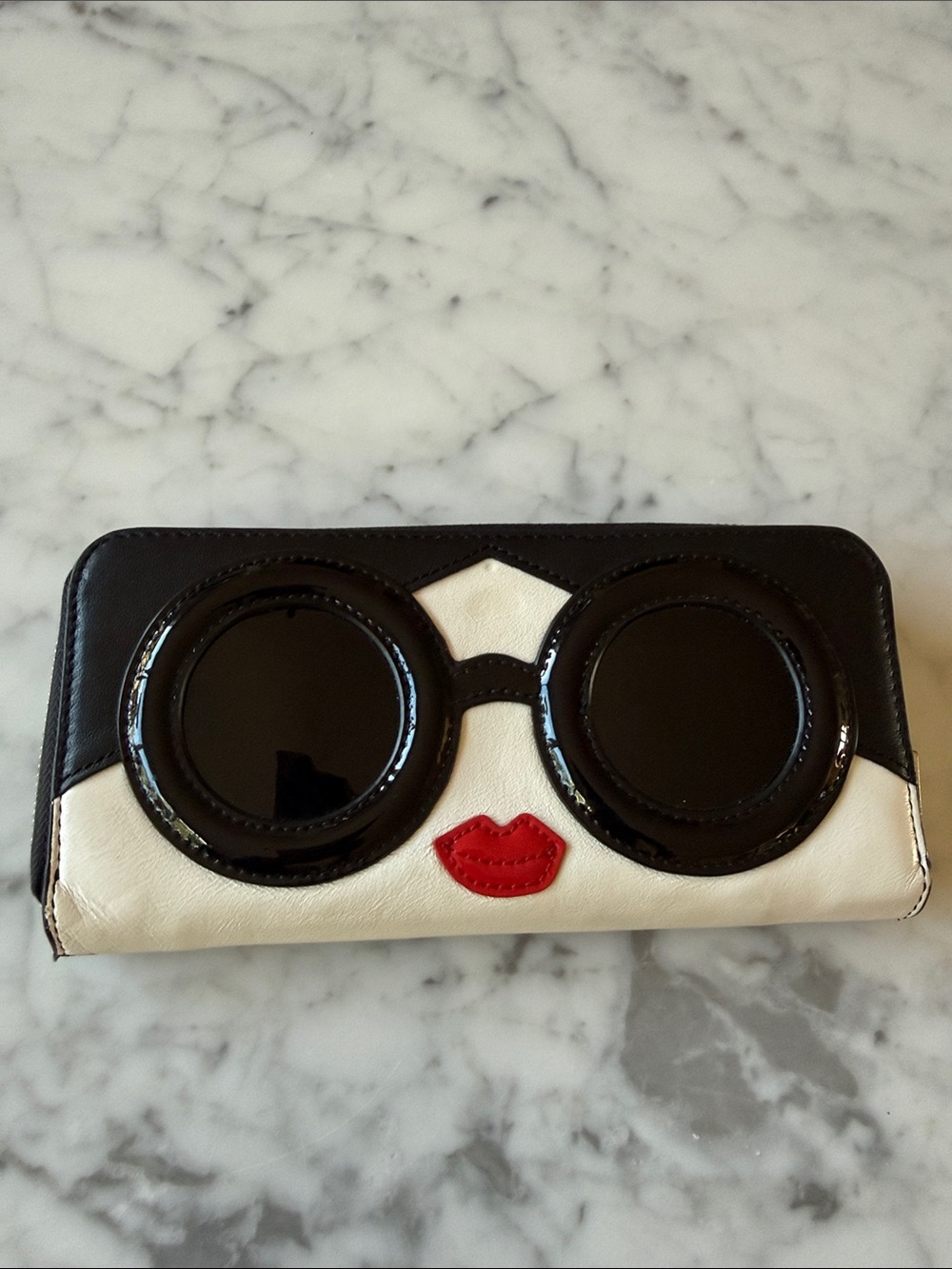 Alice and Olivia Stace Face zip around wallet. Black patent sunglasses/red lips.